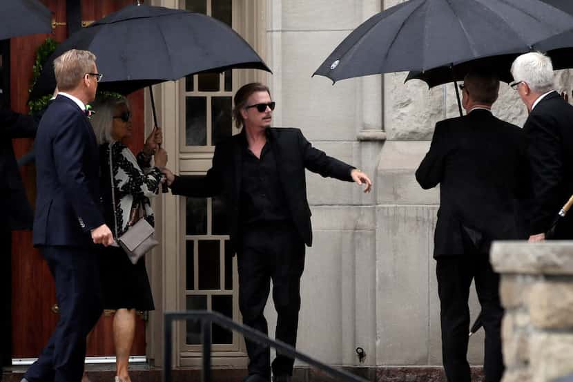 Actor-comedian David Spade helps family members enter Our Lady of Perpetual Help...