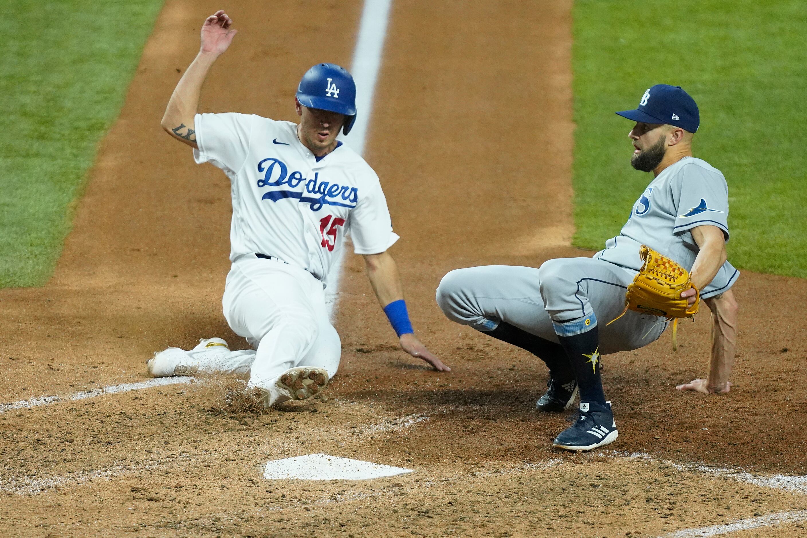Los Angeles Dodgers catcher Austin Barnes (15) scores past Tampa Bay Rays relief pitcher...
