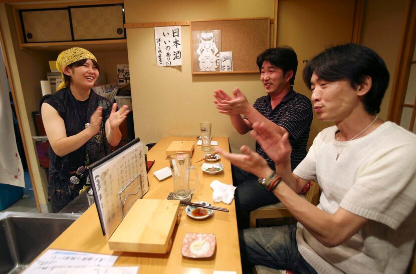 
Employee Ayaka Kurogi chats with customers at Nadeshico sushi restaurant in Tokyo, which is...