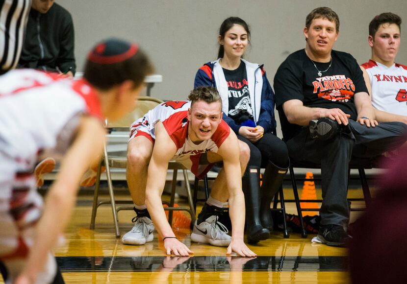 Yavneh's Pierce Bell (14) cheers from the bench during the fourth quarter of a high school...