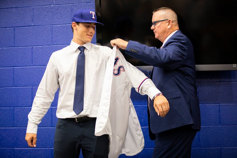 Texas Rangers 1st round pick, pitcher Cole Winn of Orange Lutheran (CA) High School, dons a...