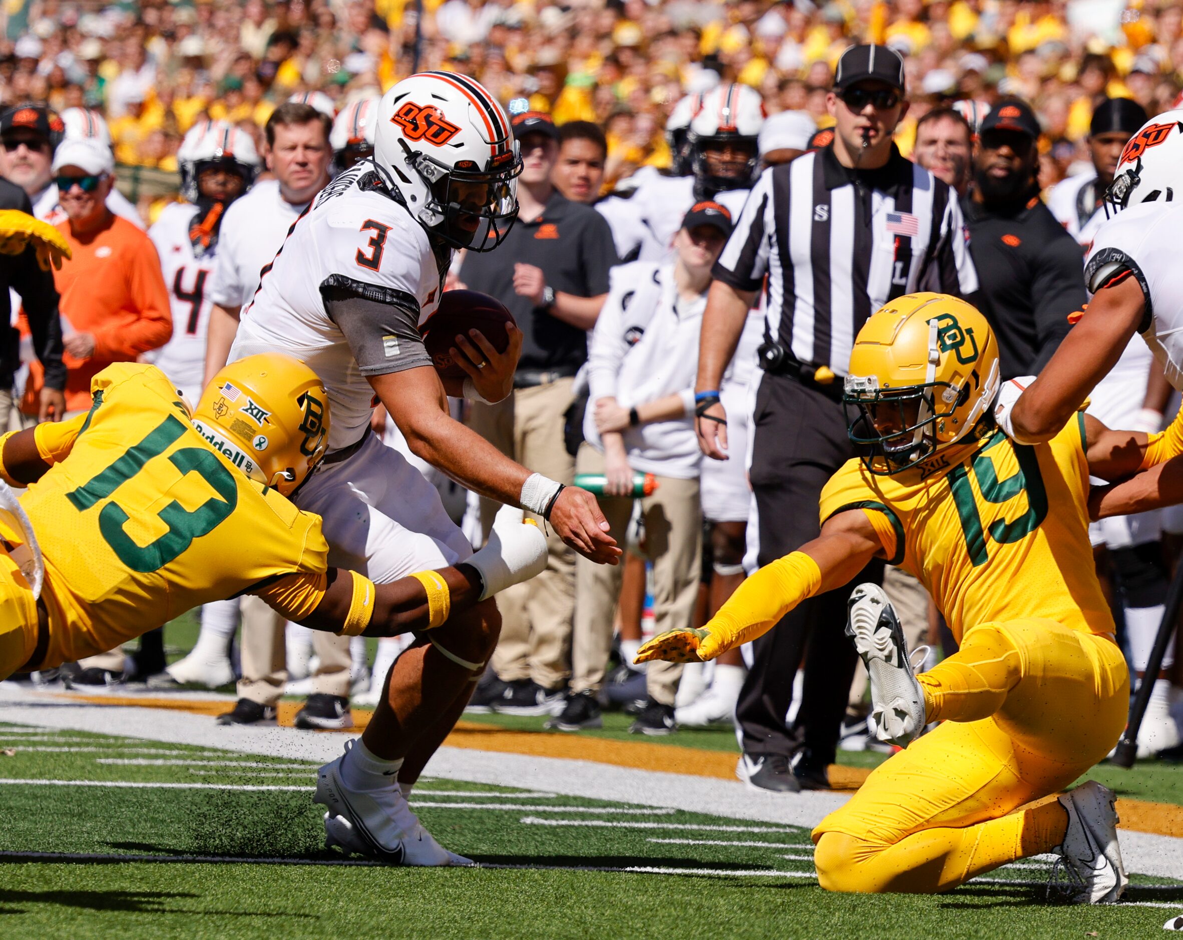 Baylor safety Al Walcott (13) tackles Oklahoma State quarterback Spencer Sanders (3) ahead...