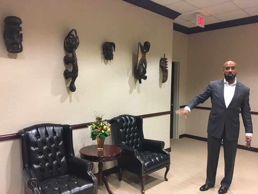 The Rev. Frederick Haynes III shows some of the African art pieces that Dallas County...