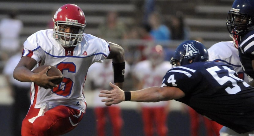 Haughton's Dak Prescott (6) rushes the ball while being defended by Airline's Dalton Elliott...