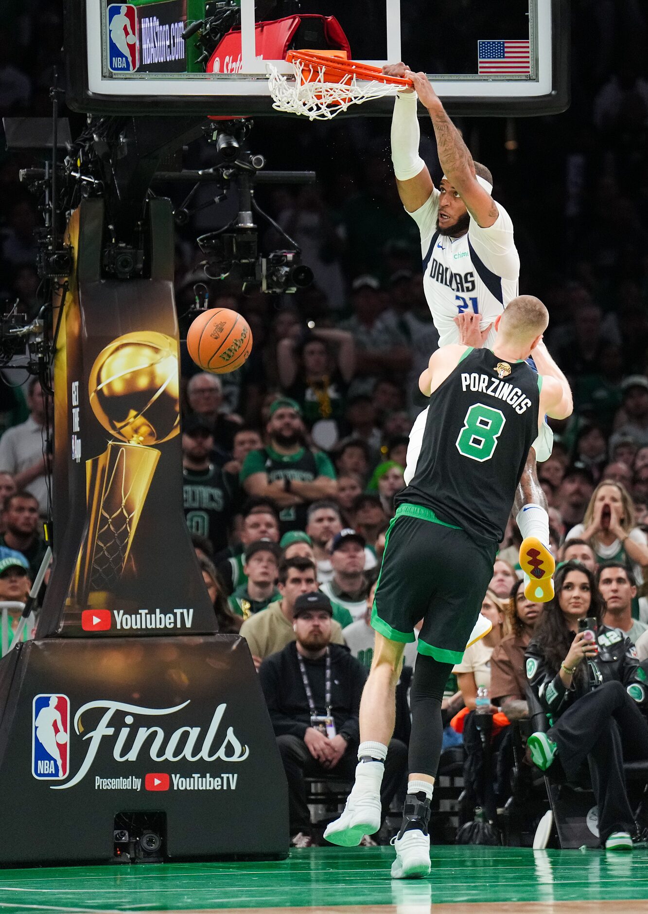 Dallas Mavericks center Daniel Gafford (21) dunks the ball past Boston Celtics center...