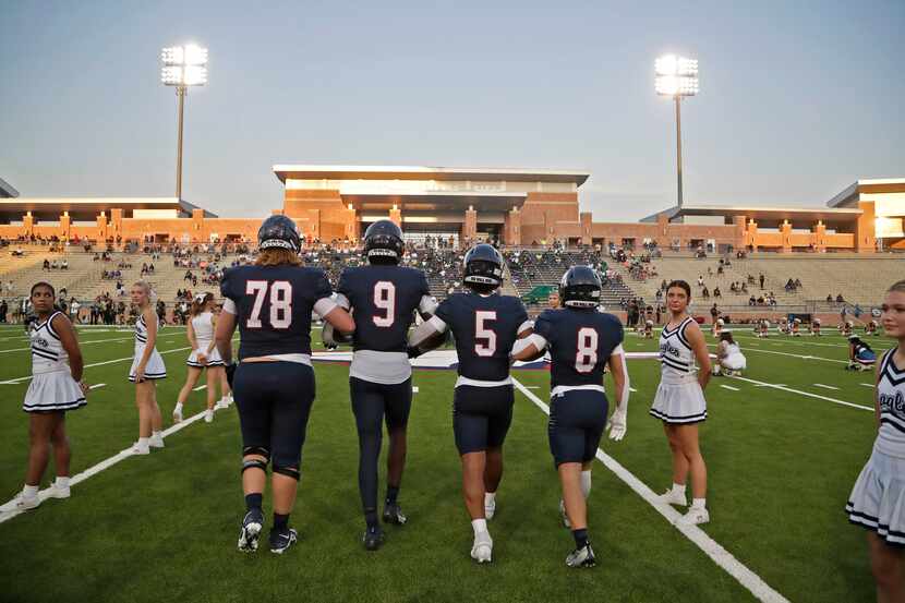 Allen High School captains head to the coin toss before kickoff as Allen High School hosted...