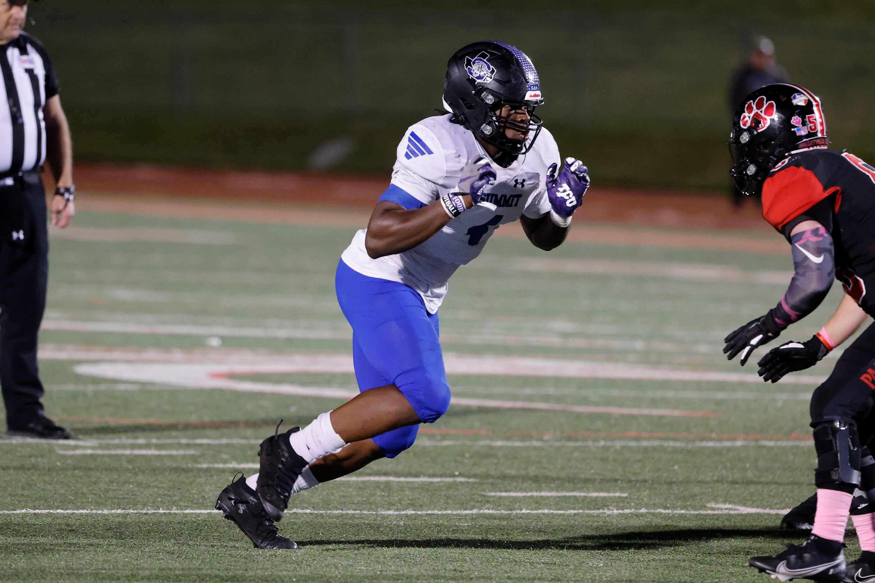 Mansfield Summit defensive lineman Joseph Adedire defends against Colleyville Heritage...