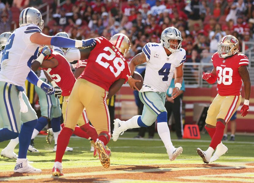 Dallas Cowboys quarterback Dak Prescott (4) rushes for a 2-yard touchdown in the fourth...