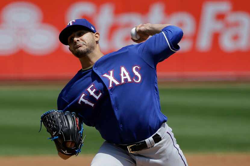 Texas Rangers pitcher Martin Perez throws against the Oakland Athletics during the first...