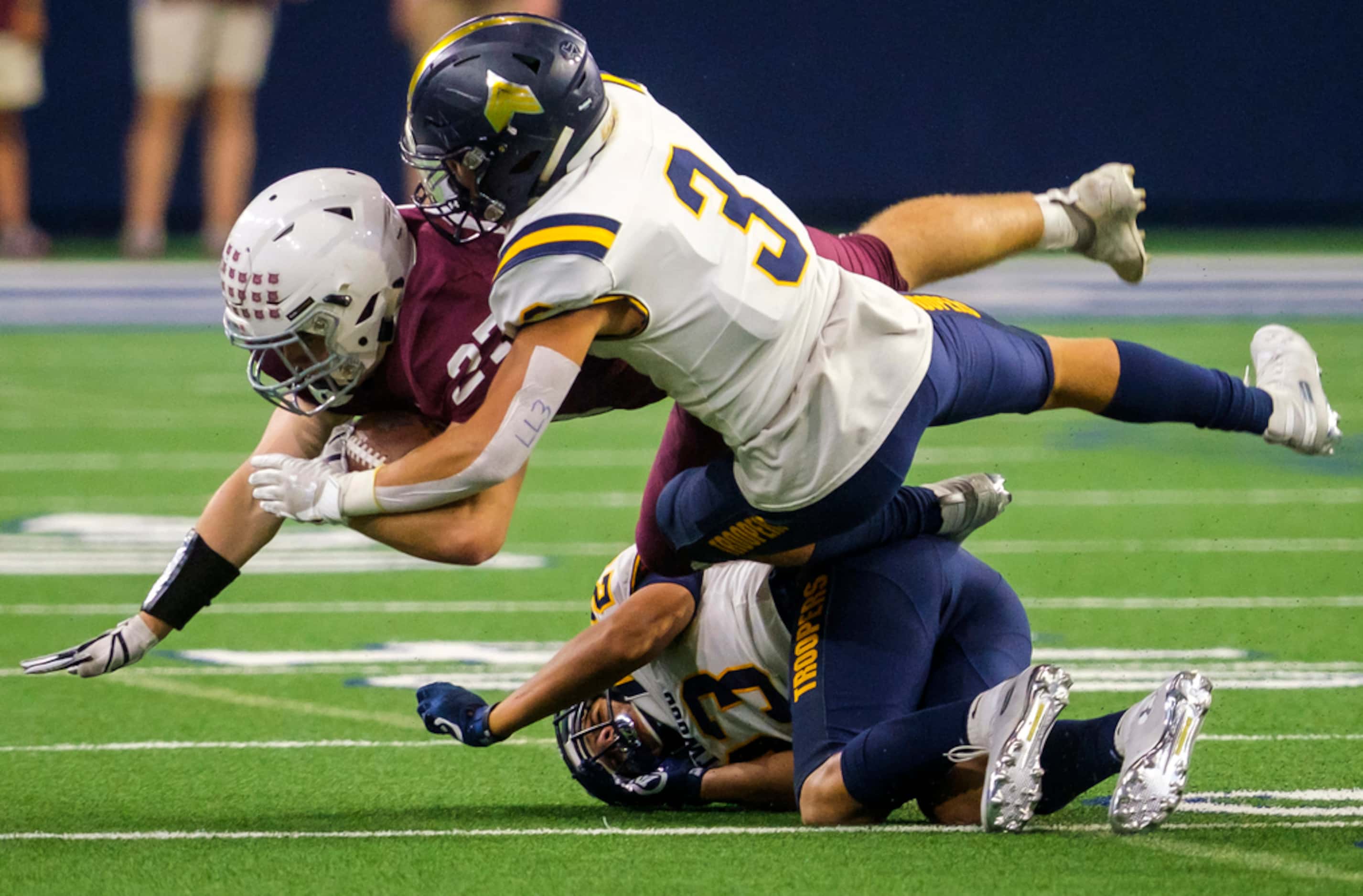 Plano running back Cody Crist (27) is knocke off his feet by El Paso Eastwood strong safety...