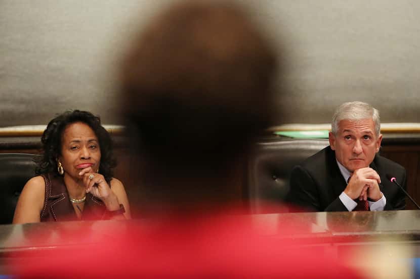 Trustee Joyce Foreman and board president Dan Micciche listen during a public hearing and...