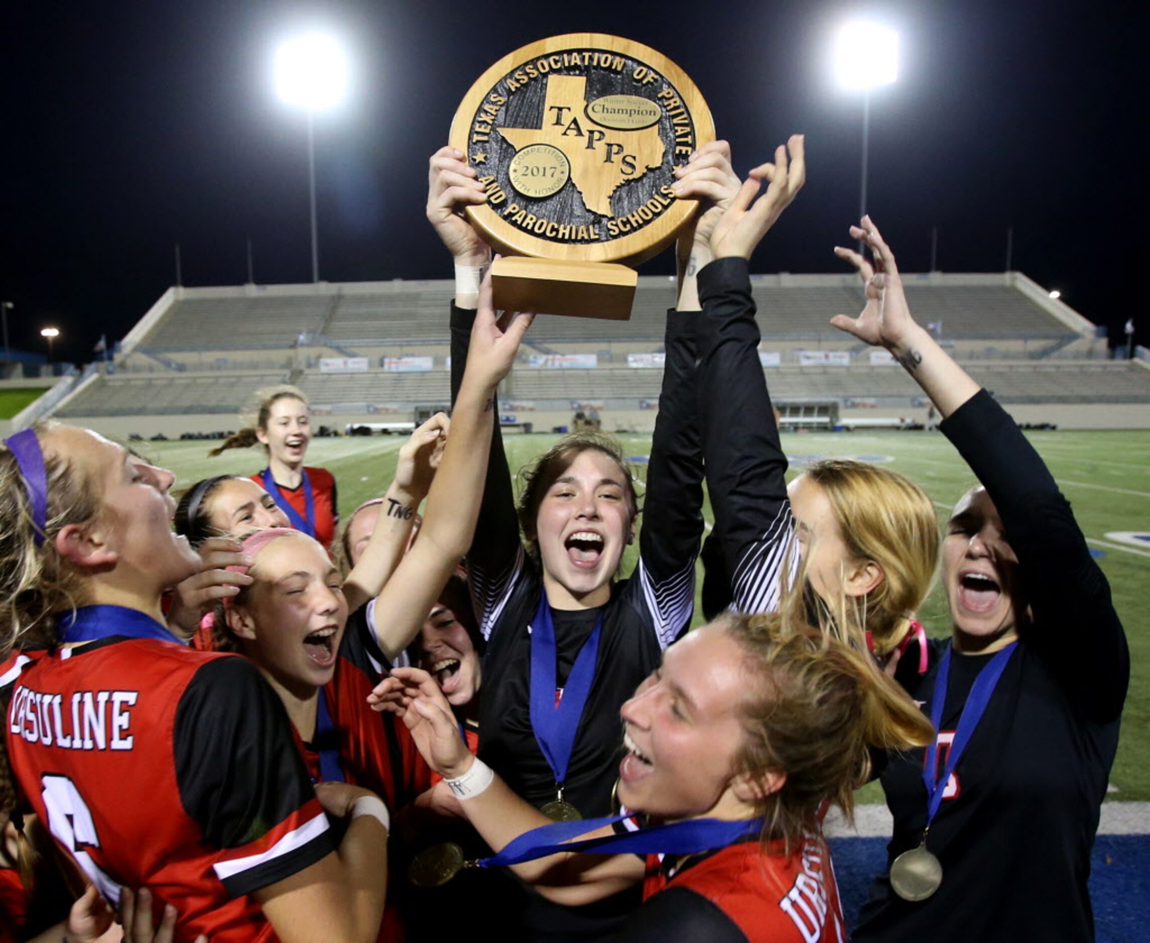 Ursuline Academys goal keeper Leah Archer (1) hoists the Division 1 TAPPS State...