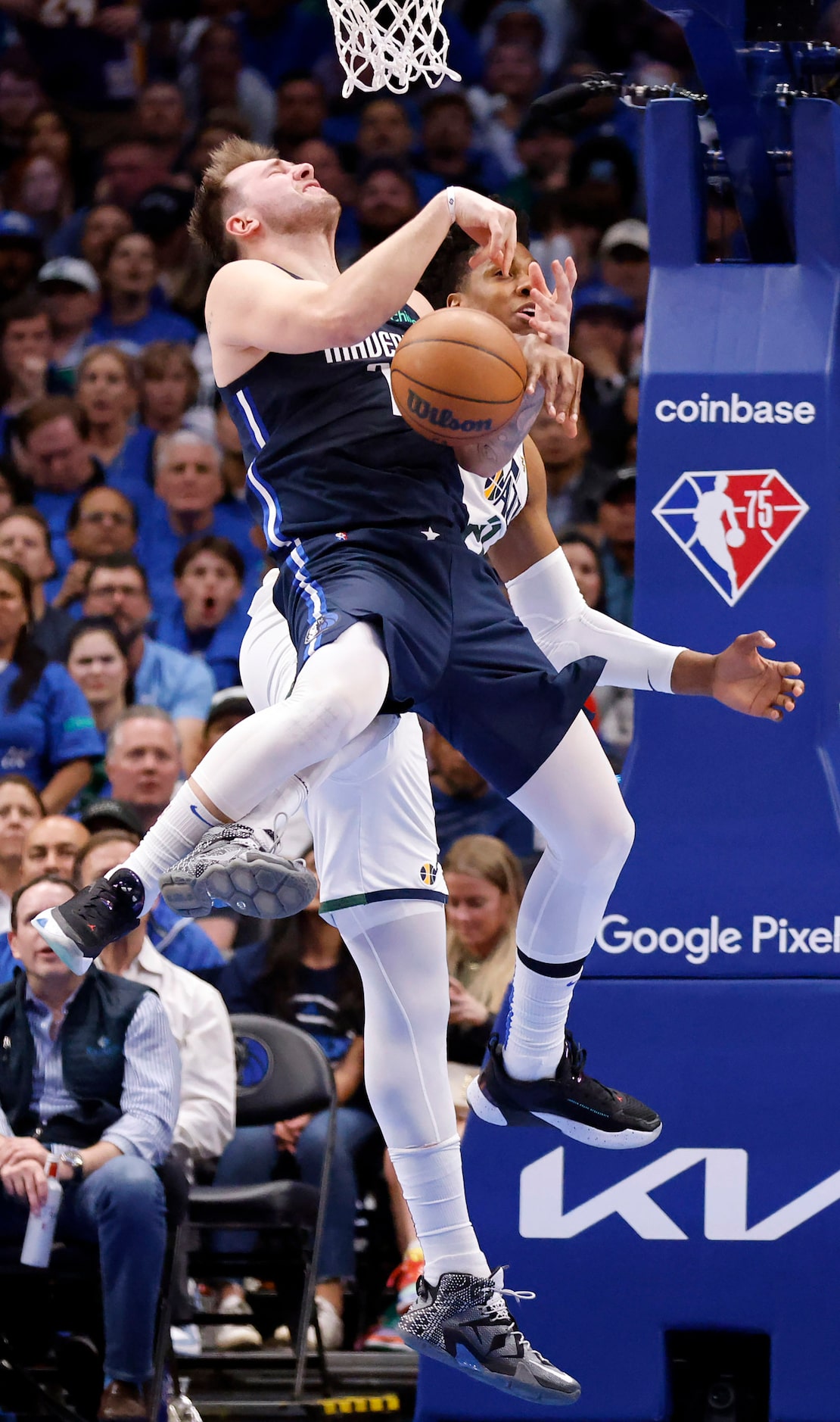 Dallas Mavericks guard Luka Doncic (77) is fouled by Utah Jazz center Hassan Whiteside (21)...