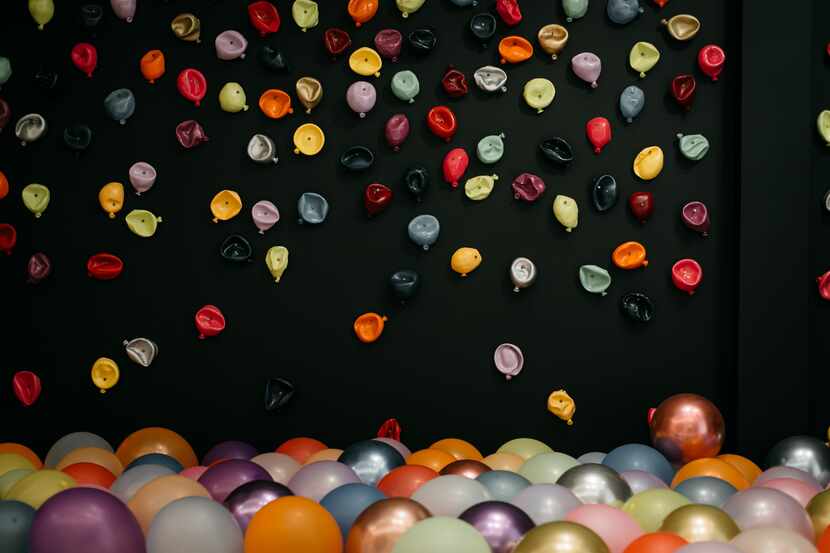 Jessica Bell’s “300 Balloons” features a wall covered with colorful balloon sculptures. Real...