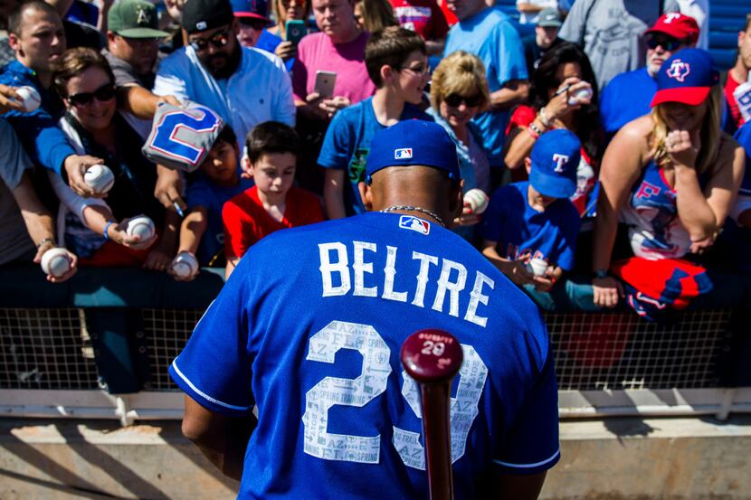 Texas Rangers third baseman Adrian Beltre (29) signs autographs for fans before a spring...