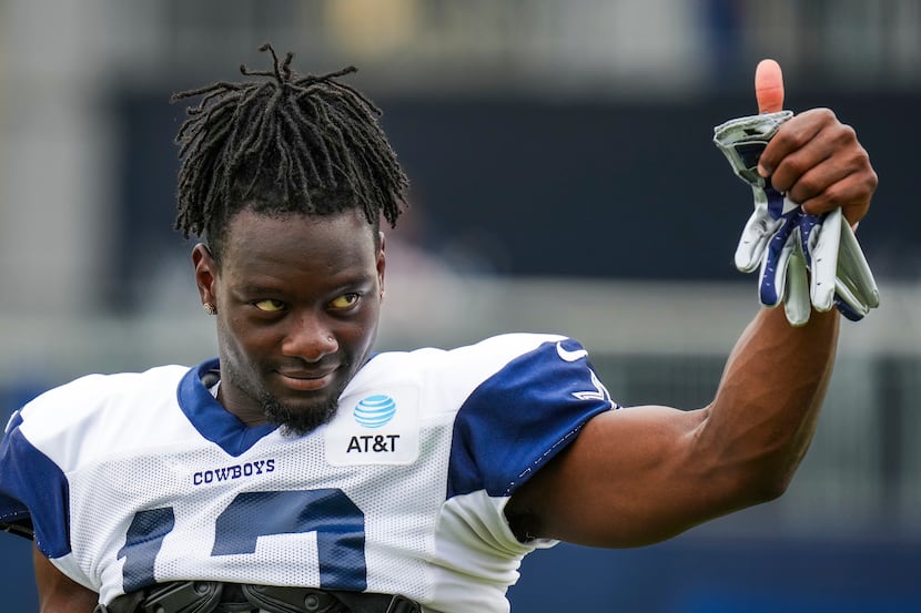 Dallas Cowboys wide receiver Michael Gallup gives a thumbs up to fans during a training camp...