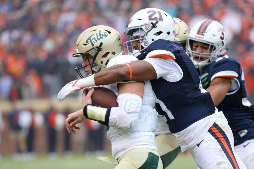 CHARLOTTESVILLE, VA - SEPTEMBER 02: Juan Thornhill #21 of the Virginia Cavaliers tackles...