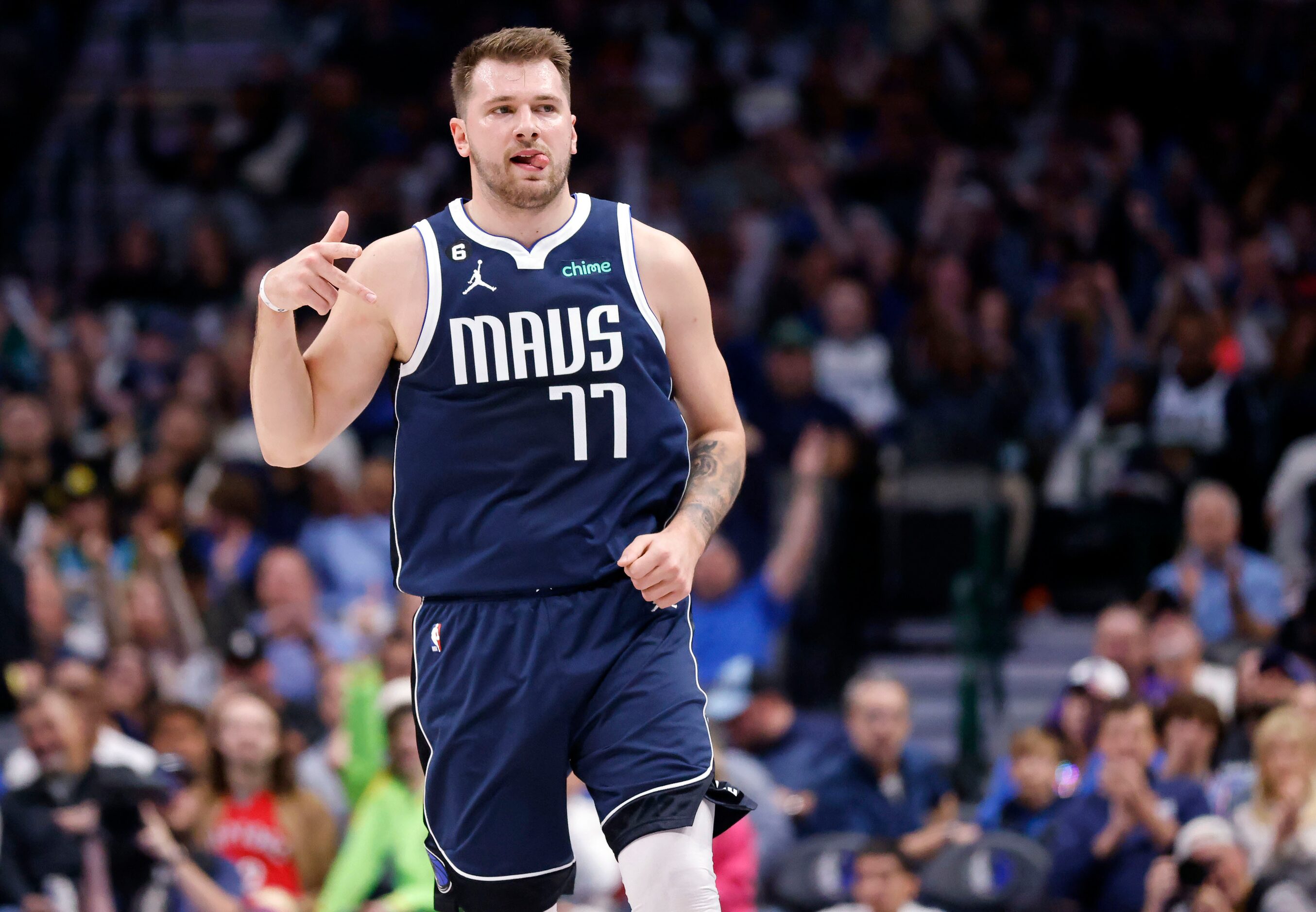 Dallas Mavericks guard Luka Doncic (77) reacts after hitting a first quarter three pointer...