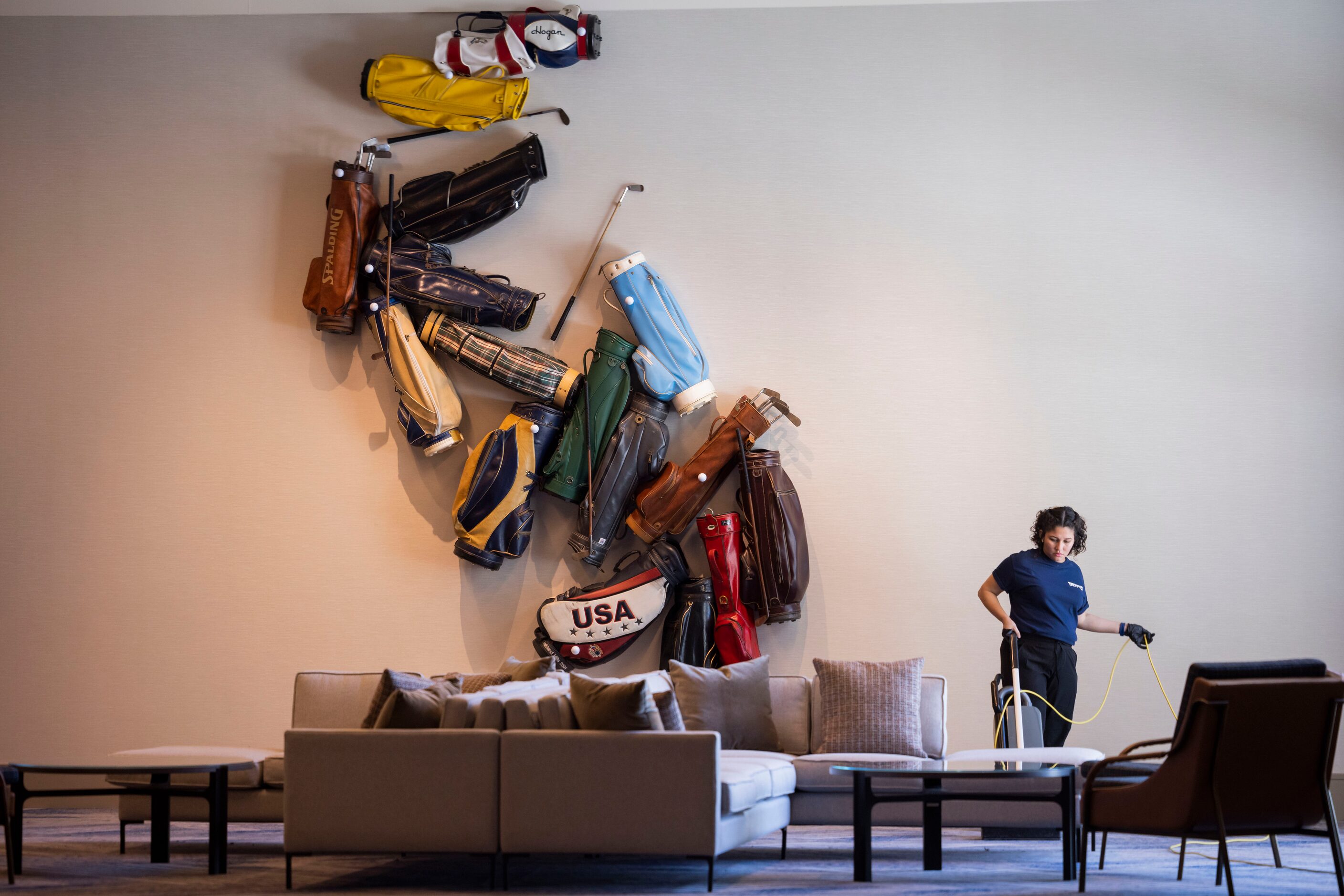 Astrid Ramirez vacuums as the final touches continue at the Omni PGA Frisco Resort in Frisco...