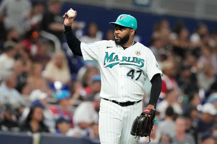 Miami Marlins starting pitcher Johnny Cueto (47) holds up a ball during the third inning of...