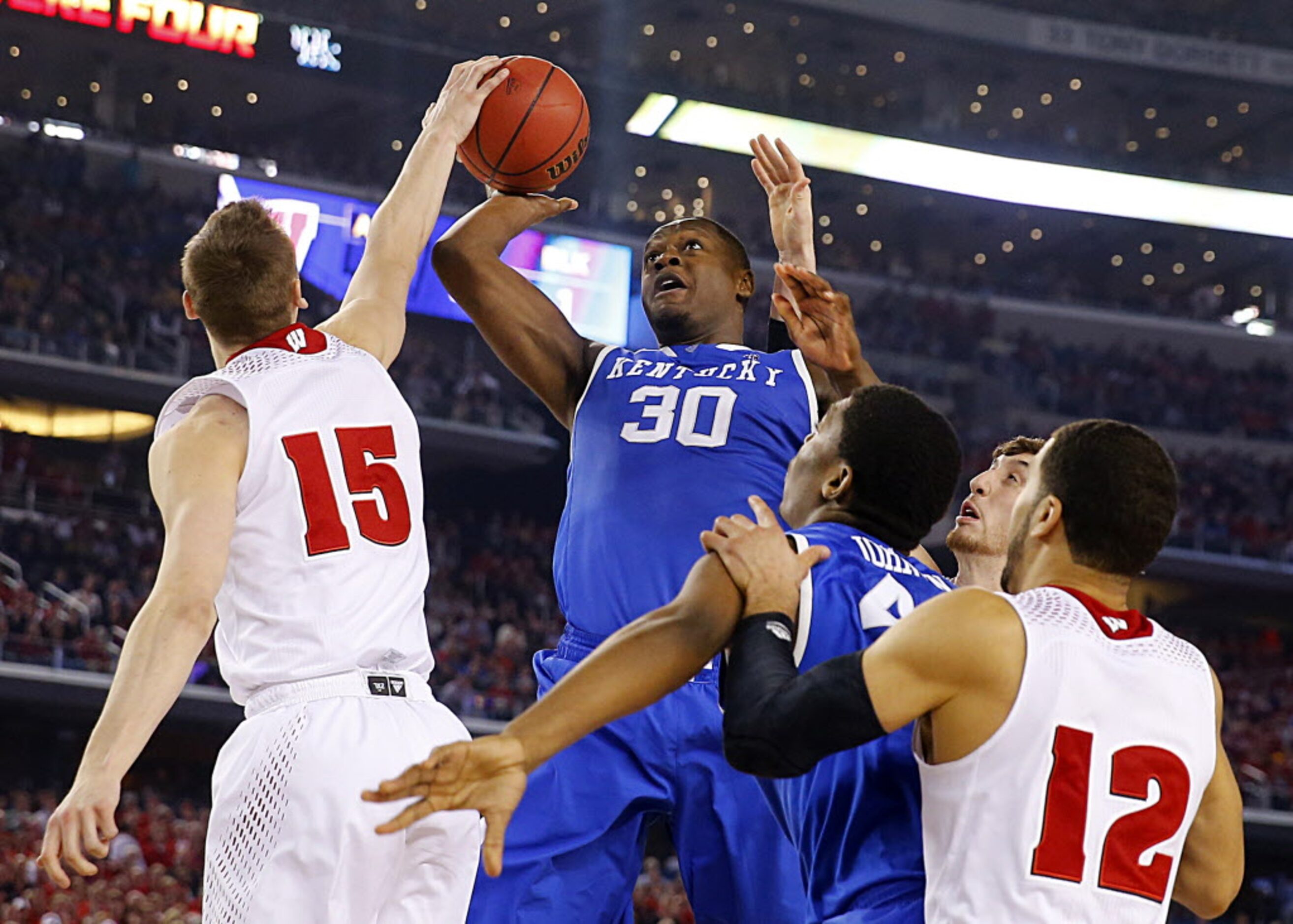 Kentucky Wildcats forward Julius Randle (30) has hius shot blocked by Wisconsin Badgers...