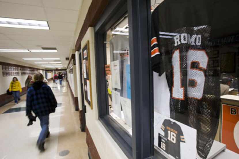 A Burlington High School football jersey of Tony Romo is seen in a window in a hall in the...
