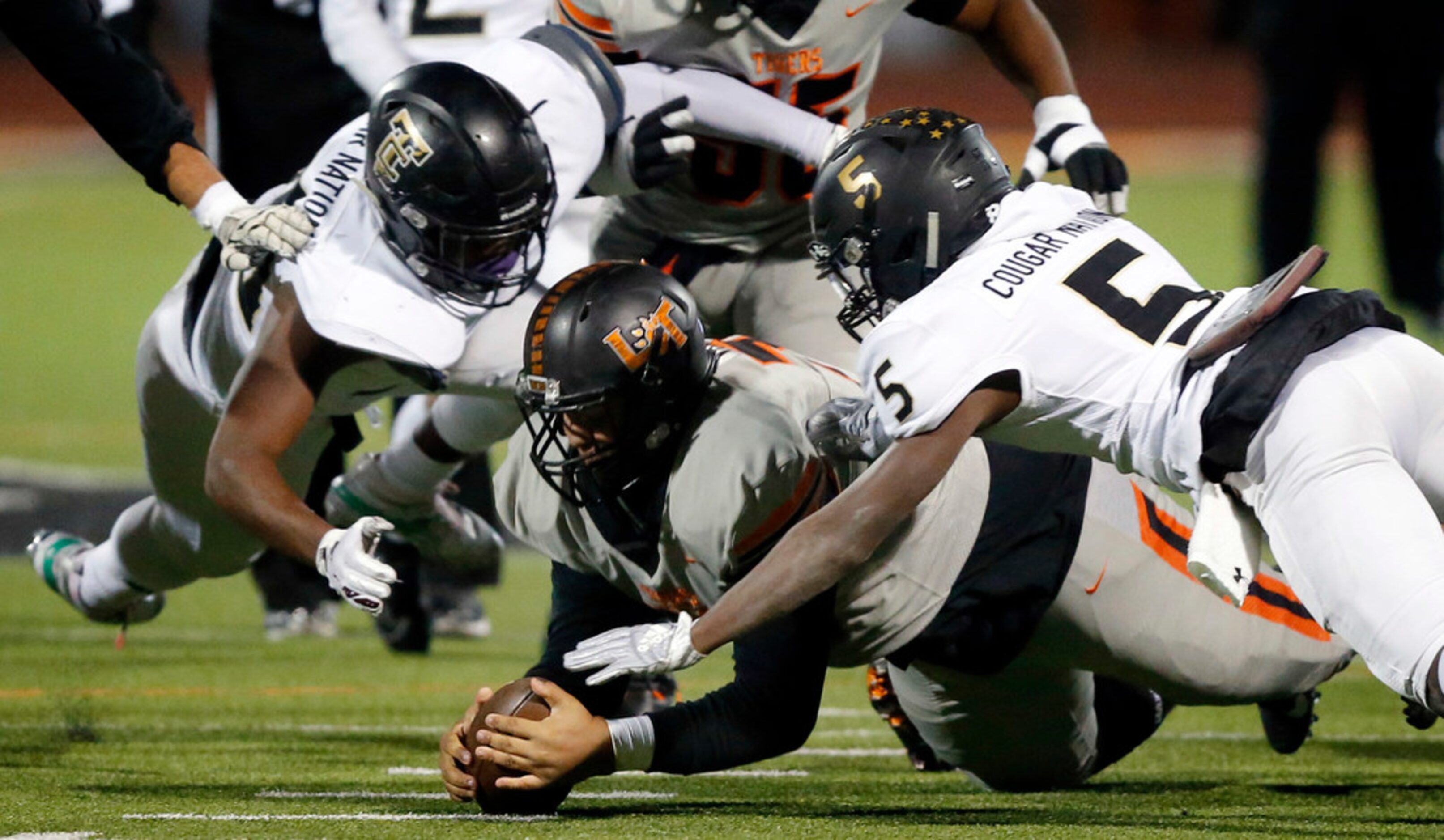 Lancaster offensive lineman Donavan Valdez pounces on a fumble as The Colony defenders Dom...