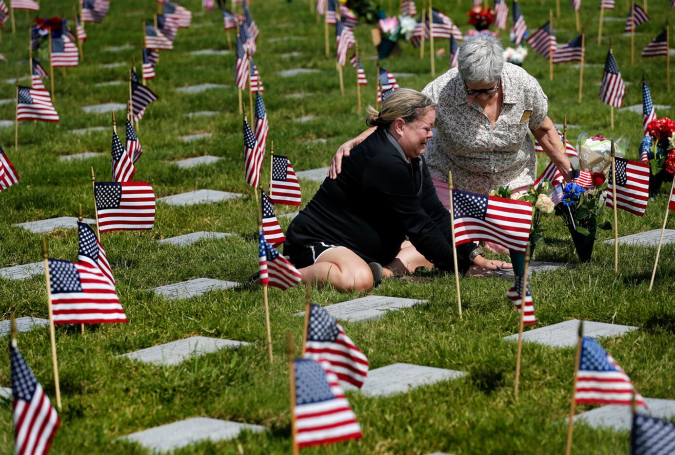 Cynthia Reeves of Fort Worth (right) came over to console Samantha Mote Bingham of Arlington...