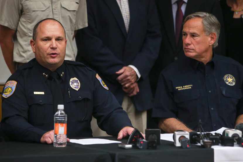 Odessa Police Chief Michael Gerke, left, speaks alongside Texas Governor Greg Abbott during...