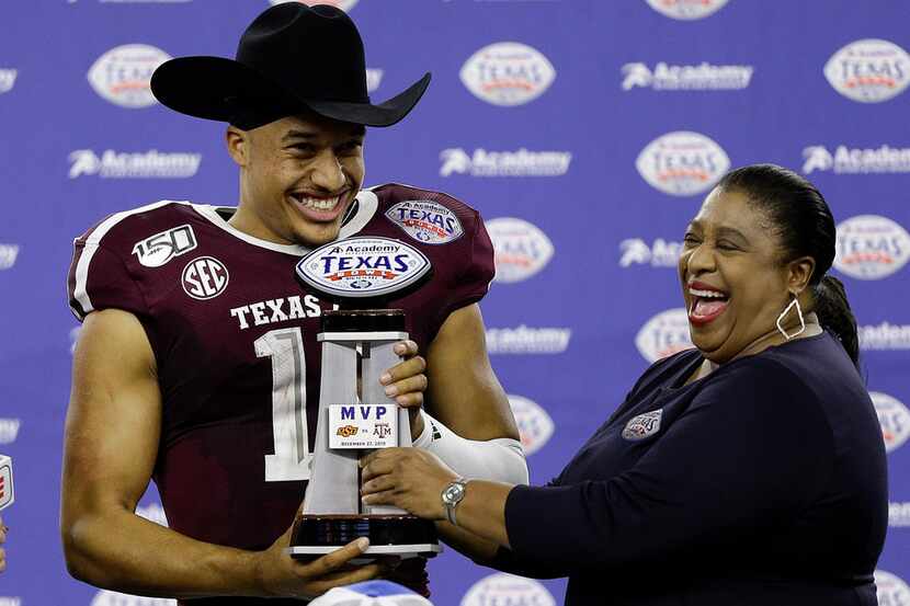 FILE - Texas A&M quarterback Kellen Mond receives the game's MVP trophy after the Aggies...