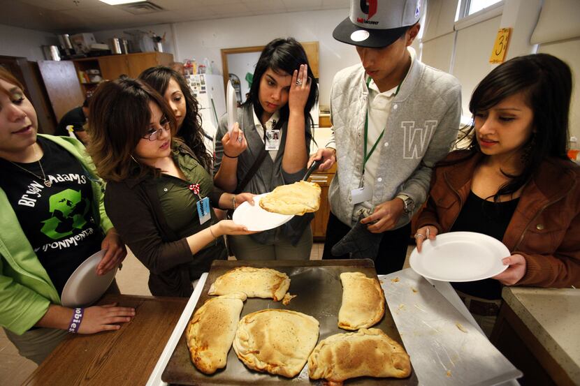 Culinary Arts student Christian Garcia (second from right) serves calzones, the dish of the...