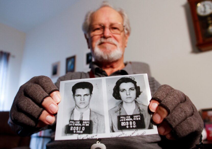 David Myers holds a copy of the booking photos of himself and his then-girlfriend, Winonah...