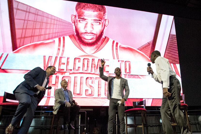 Chris Paul waves to fans after being introduced as the newest member of the Houston Rockets...