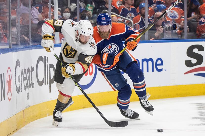 Vegas Golden Knights' Ivan Barbashev (49) and Edmonton Oilers' Mattias Ekholm (14) battle...