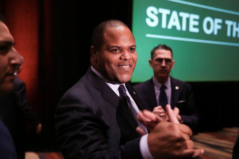 Dallas Mayor Eric Johnson shakes hands with an attendee following the annual State of the...