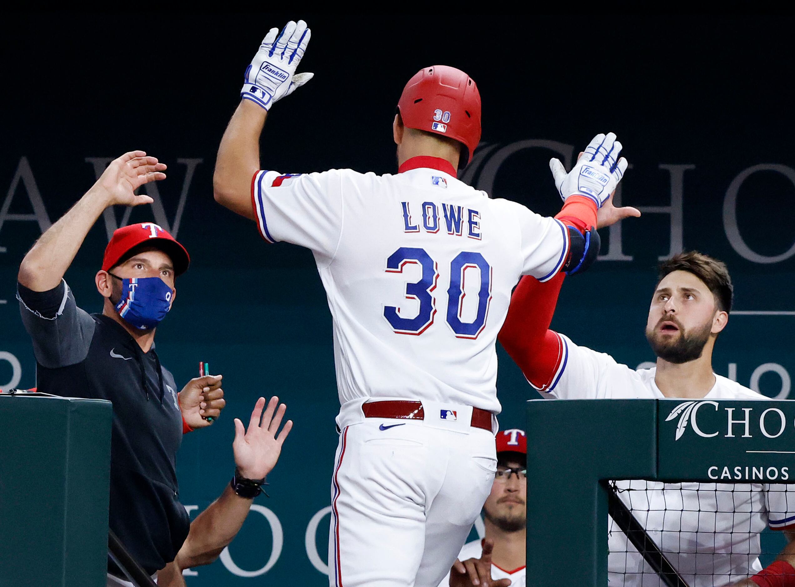 Texas Rangers Nate Lowe (30) is congratulated by teammate Joey Gallo (right) and manager...