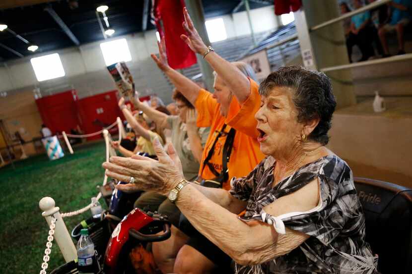 Michele Miller, 74, cheers during the pig race at the State Fair of Texas at Fair Park in...