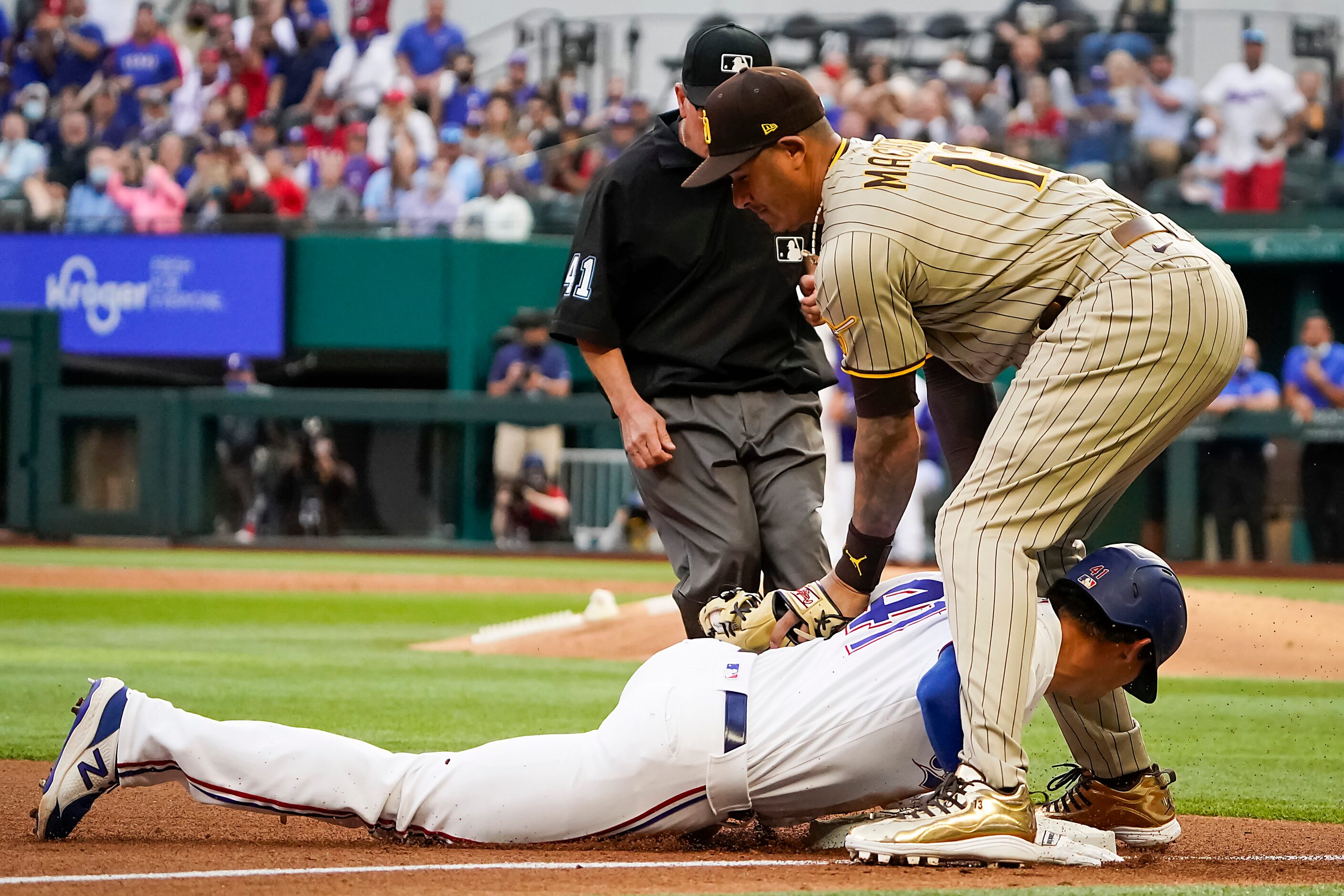 Texas Rangers outfielder Eli White is safe with an RBI triple ahead of the tag from San...