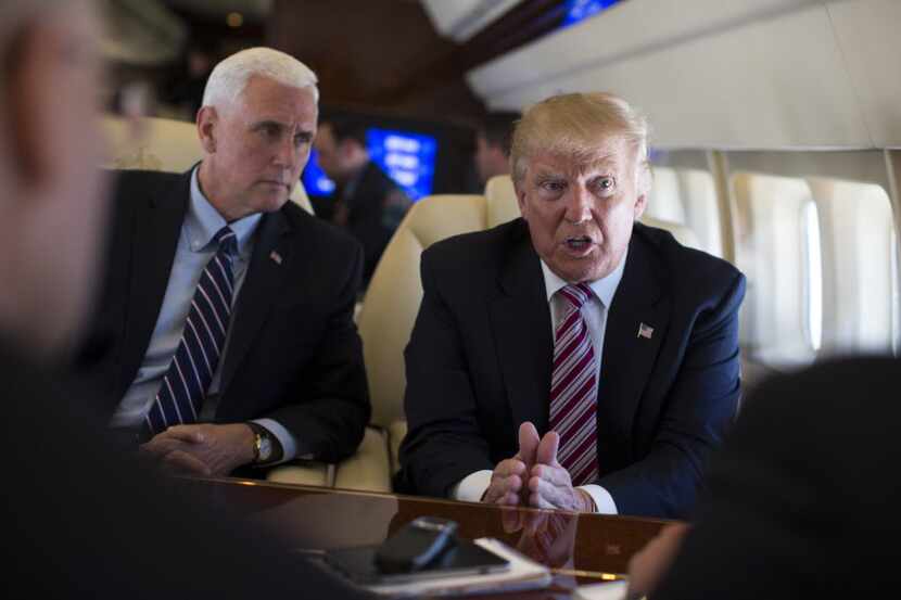 Republican presidential candidate Donald Trump talks with the press as he flies on board his...