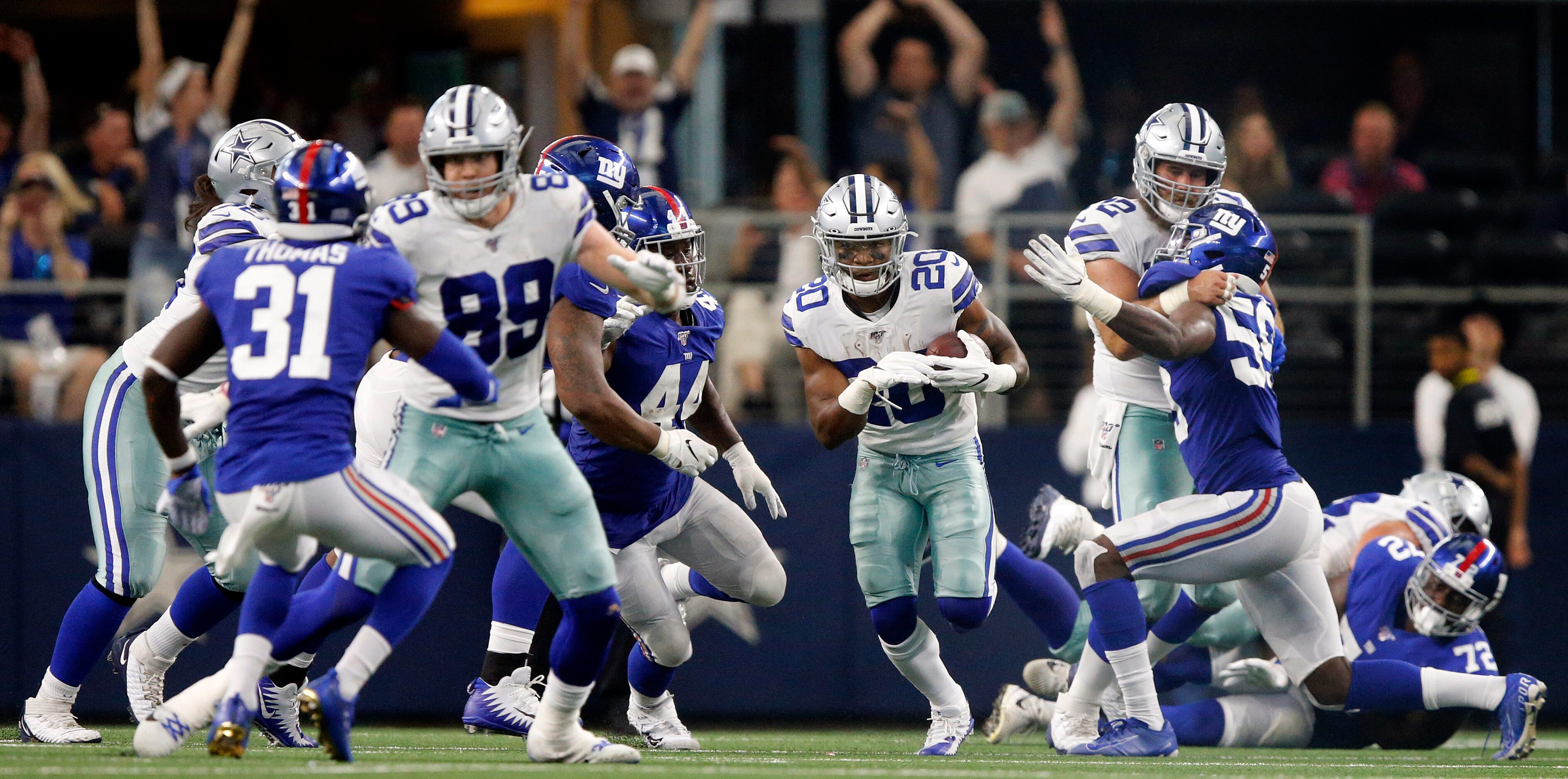 Dallas Cowboys running back Tony Pollard (20) carries the ball late in the fourth quarter...