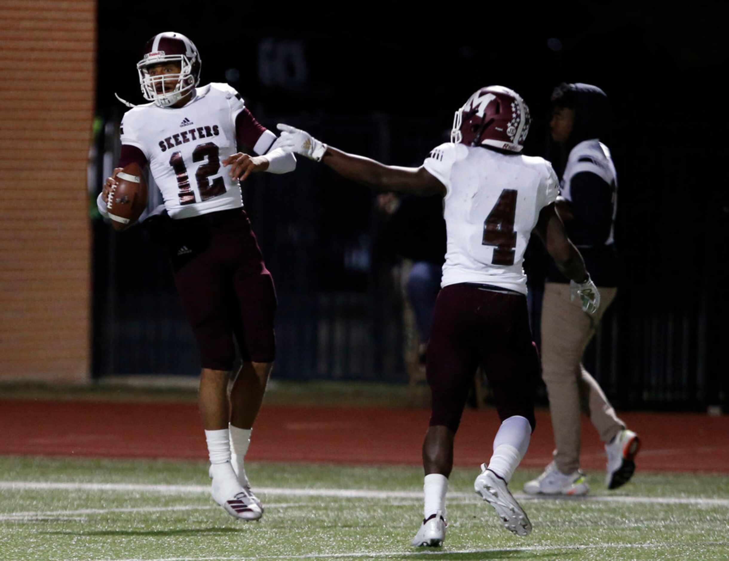 Mesquite's Dylan Hillard-McGill (12) and LaDarius Turner (4) celebrate after a touchdown...