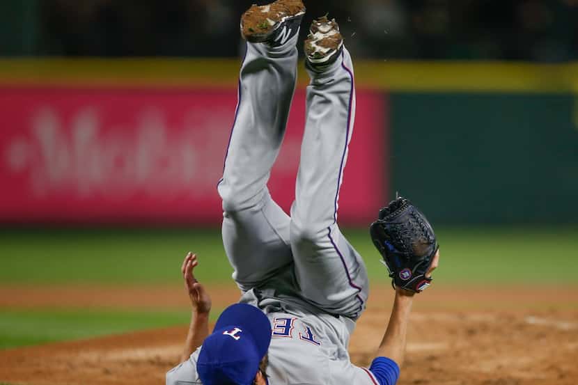 SEATTLE, WA - SEPTEMBER 08: Starting pitcher Cole Hamels #35 of the Texas Rangers tumbles...