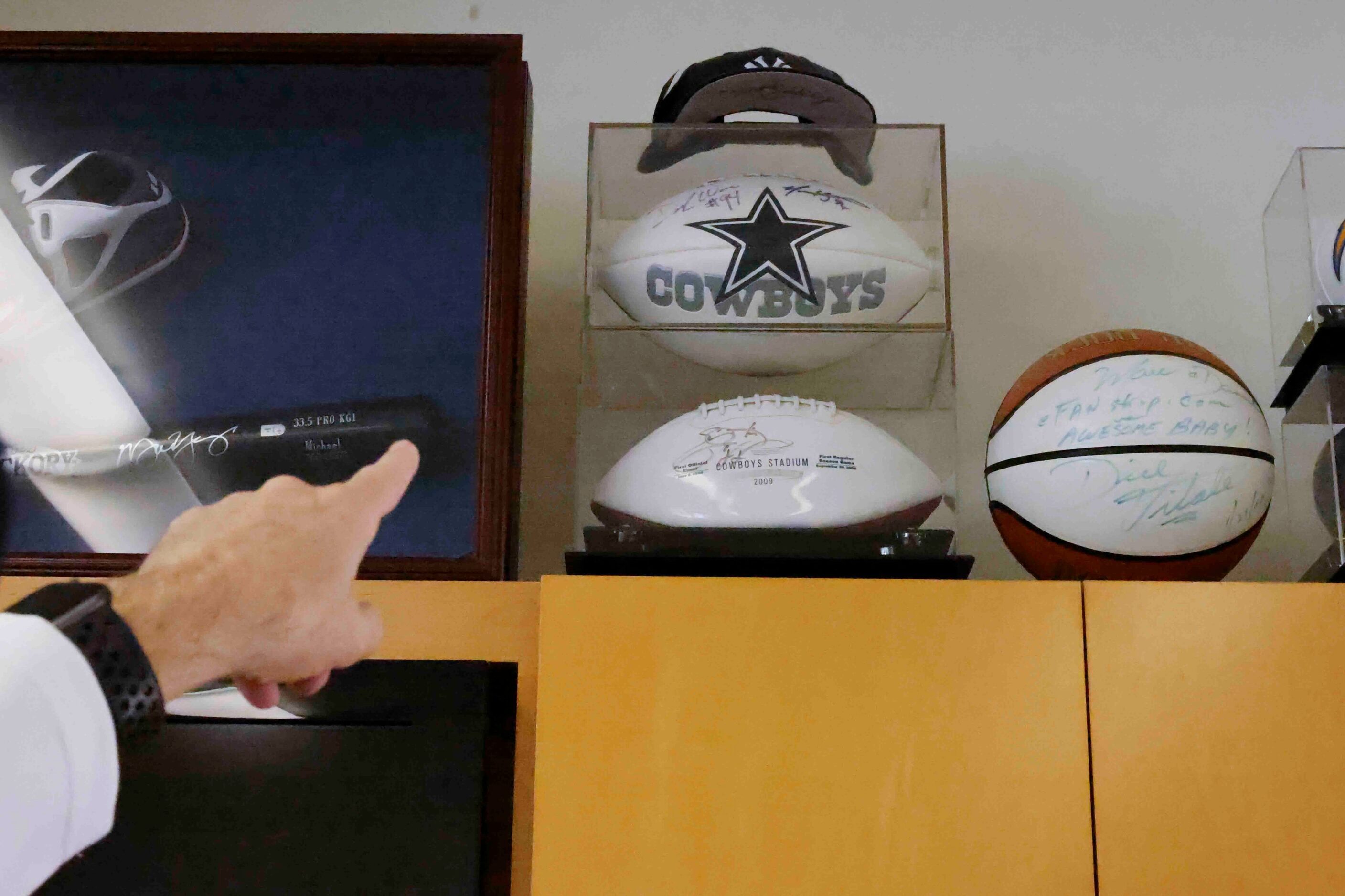 Marc Andres points to part of his Dallas Cowboys memorabilia at his residence on Wednesday,...