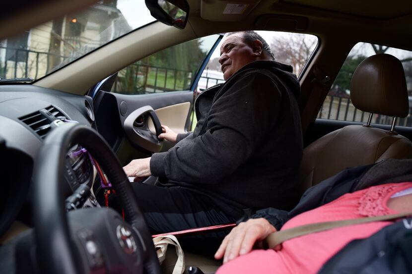 Steven Valdez, 64, enters Julia Gibson's car for his ride to a doctor's appointment. The...