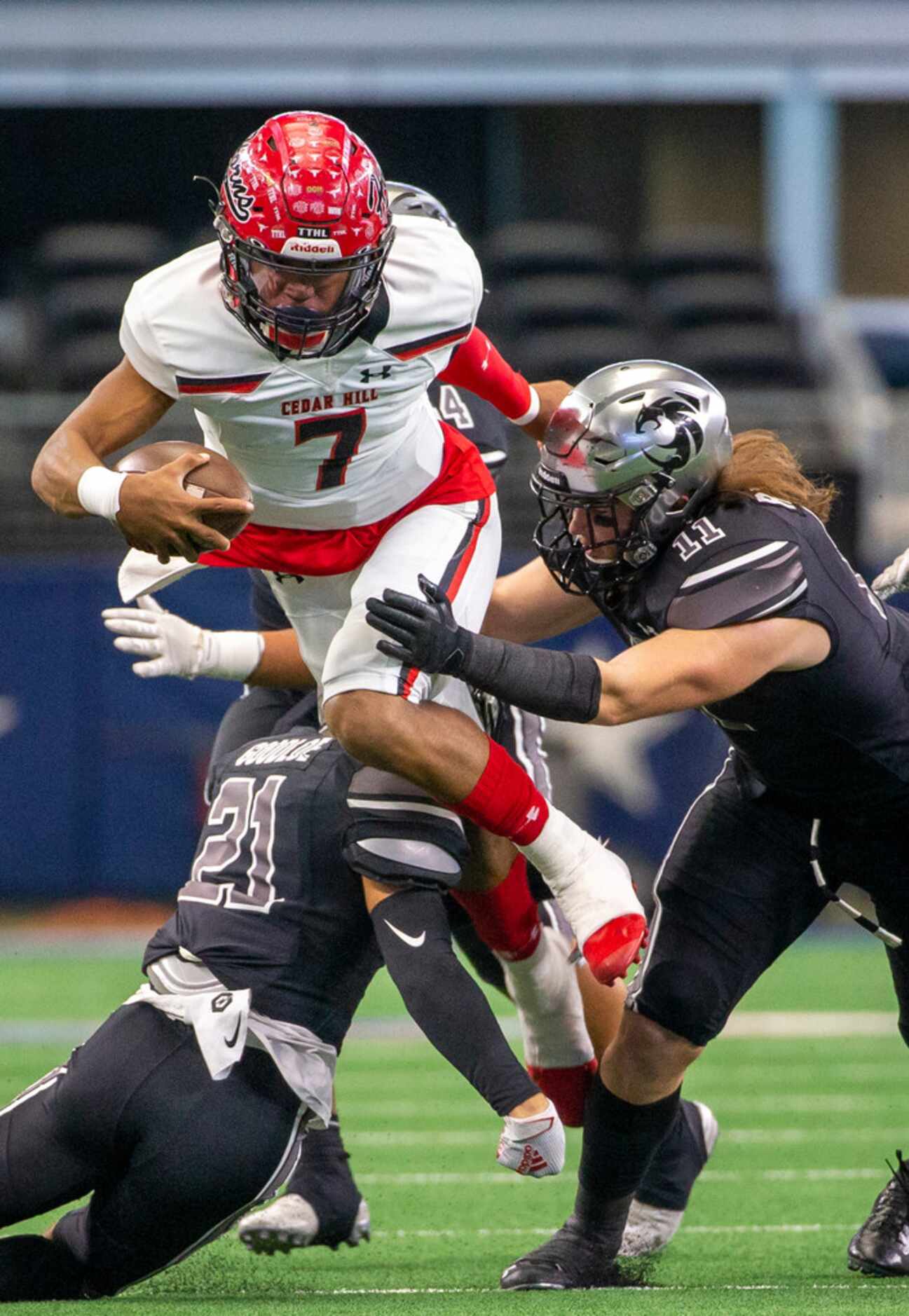 Cedar Hill quarterback Kaidon Salter (7) gets sacked by Denton Guyer linebacker Cole Ramsey...