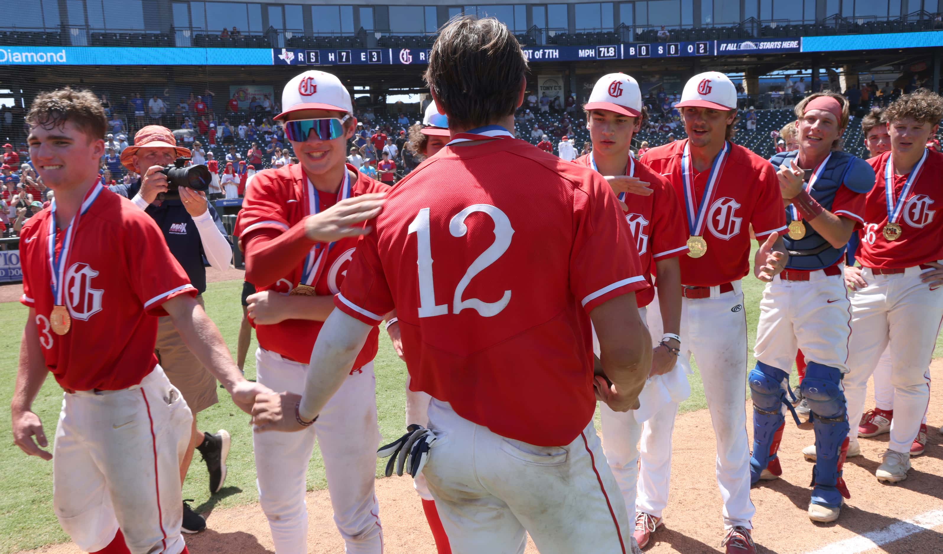 Grapevine players congratulate first baseman Jarett Boswell (12) after he was named most...