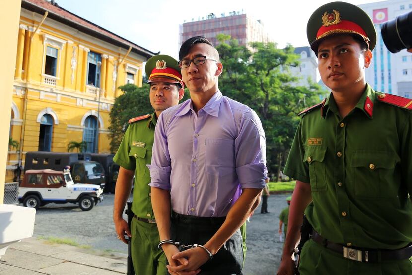 Vietnamese police escorted American citizen William Nguyen to court July 20. Nguyen was...