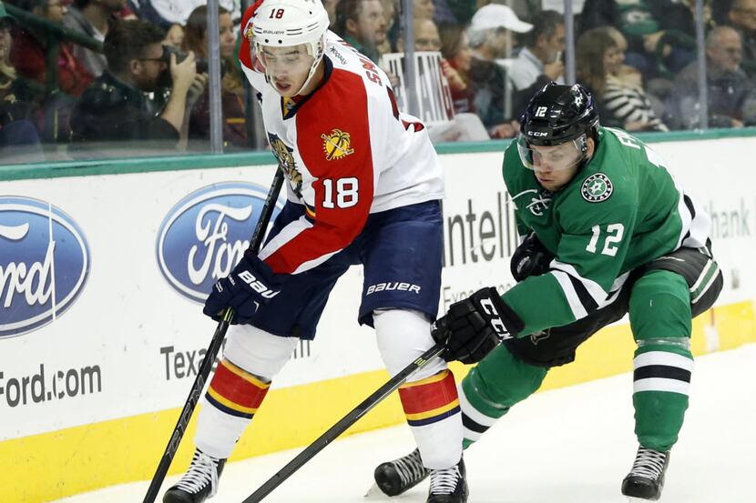 Florida Panthers right wing Reilly Smith (18) and Dallas Stars center Radek Faksa (12) go...