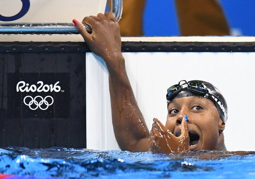 U.S. swimmer Simone Manuel reacts after seeing her first-place finish on the scoreboard in...