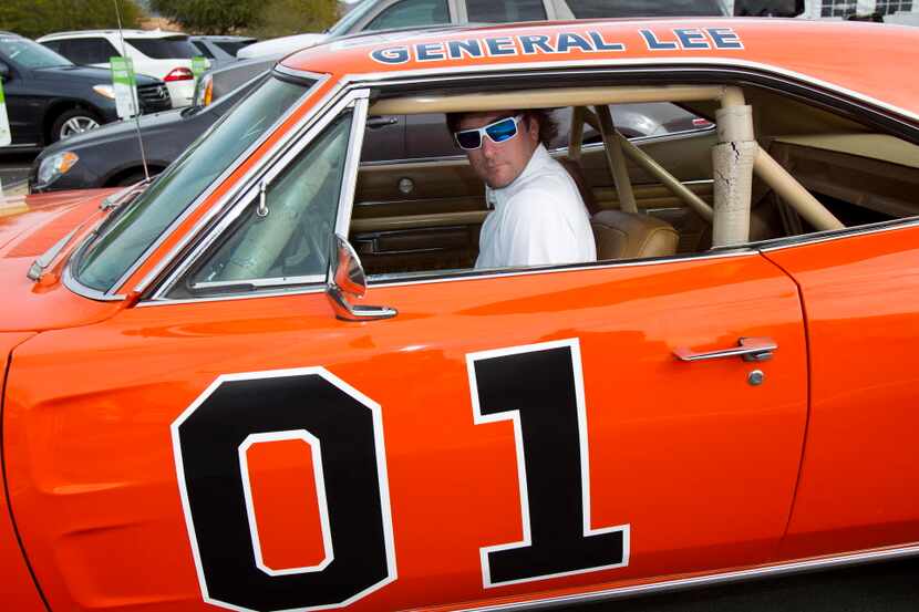 FILE - In this Feb. 1, 2012, file photo, golfer Bubba Watson drives off in the General Lee...